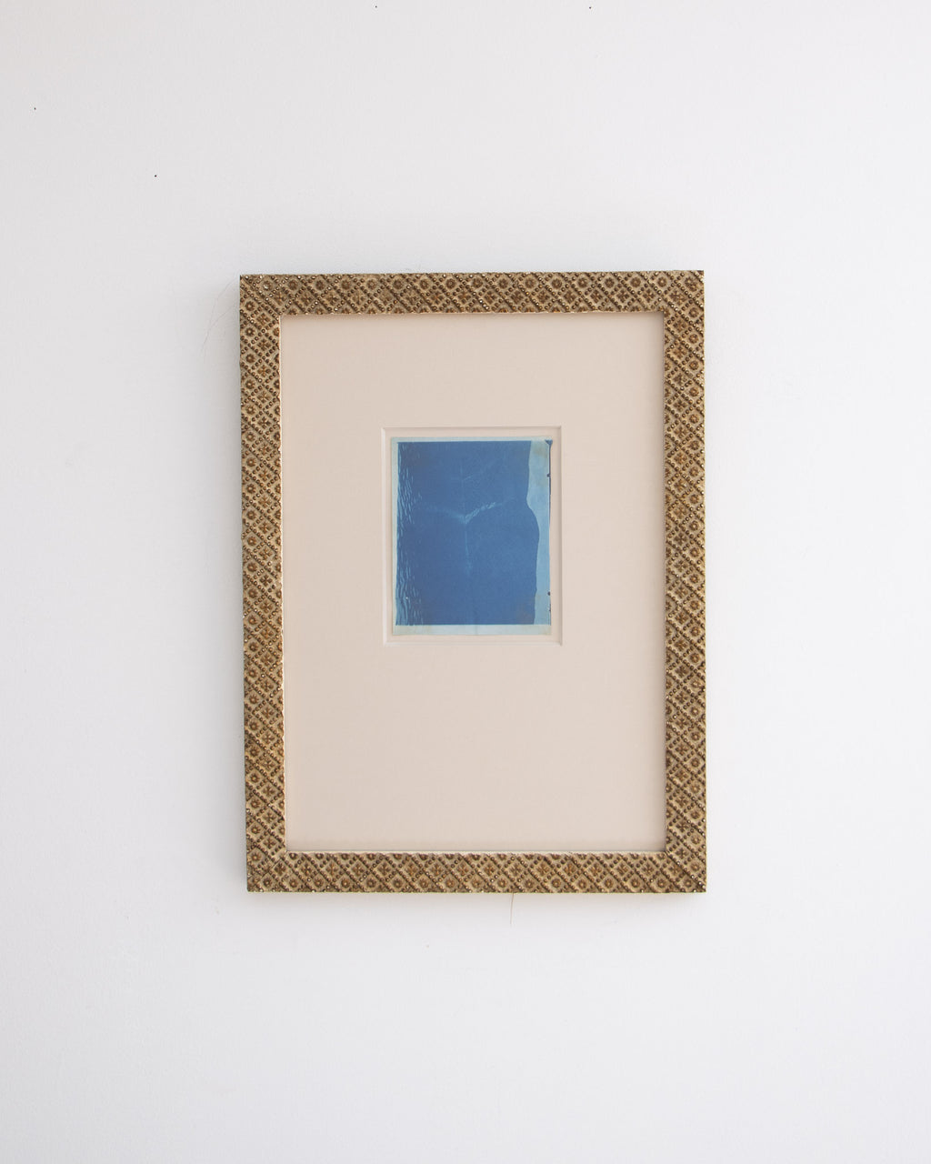 Framed cyanotype photograph on a white background