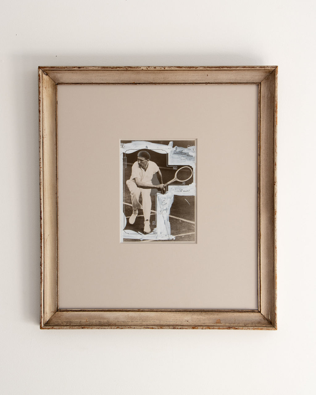 Framed black and white photo of a tennis player on a plain background